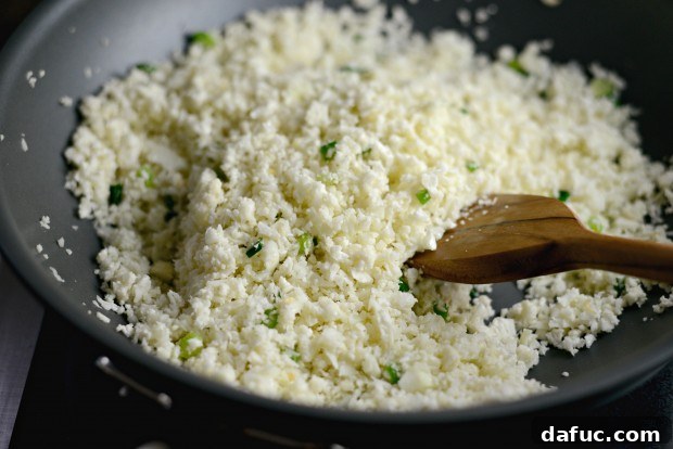 Adding Cauliflower Rice to the Stir-Fry Pan l SimplyScratch.com