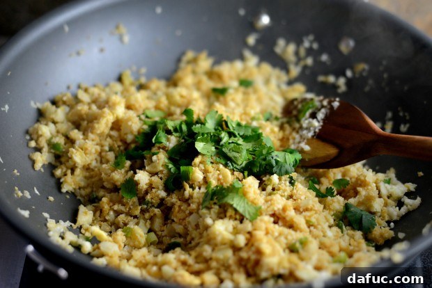 Pouring Lemongrass Tamari Sauce over Cauliflower Fried Rice l SimplyScratch.com