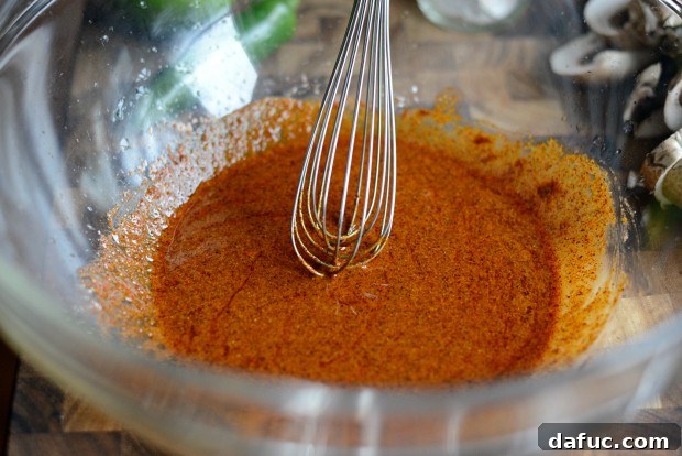 Mixing olive oil, lime juice, and fajita seasoning in a bowl