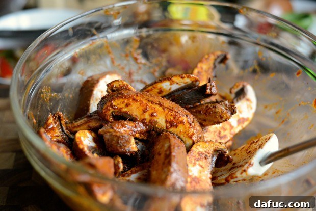 Tossing portobello mushrooms with fajita seasoning