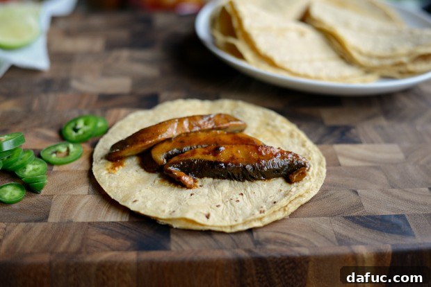 Placing portobello mushroom strips on corn tortillas