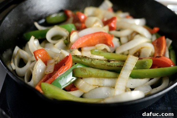 Close-up of charred bell peppers and onions after cooking