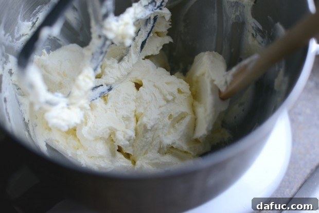 Ultimate Classic Cream Cheese Frosting 8 Scraping down the sides of the mixer bowl
