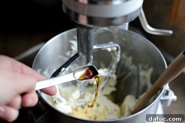 Ultimate Classic Cream Cheese Frosting 9 Adding vanilla extract to the frosting mixture