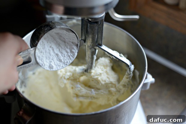 Ultimate Classic Cream Cheese Frosting 10 Gradually adding powdered sugar to the mixer