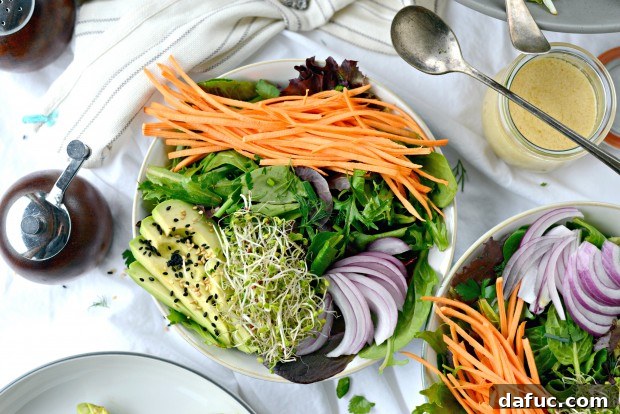Shaved Raw Sweet Potato and Creamy Avocado Salad with Miso Dressing 15 Assembling Avocado and Raw Sweet Potato Salad, layering greens, sweet potato, avocado, and onion.