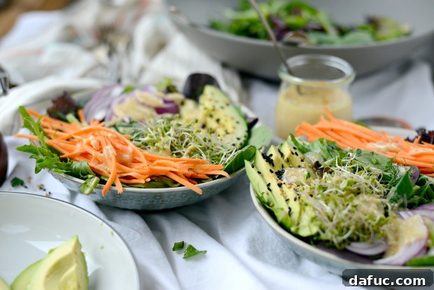 Shaved Raw Sweet Potato and Creamy Avocado Salad with Miso Dressing 19 A beautifully presented serving of Avocado, Raw Sweet Potato, and Herbed Salad with Miso Dressing, ready to be enjoyed.
