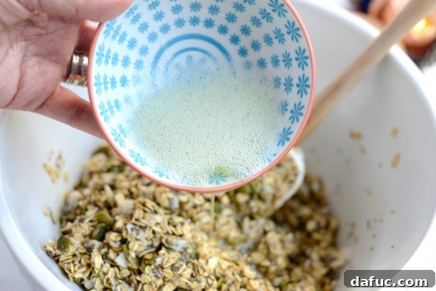 Tropical Coconut Chia Granola 12 Stirring granola mixture to combine flavors