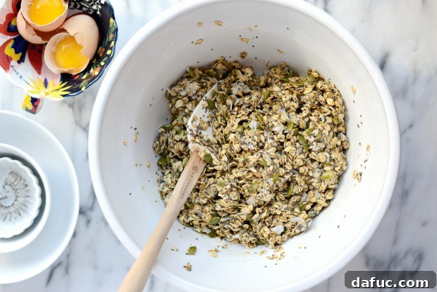 Tropical Coconut Chia Granola 13 Adding frothy egg whites to granola mix