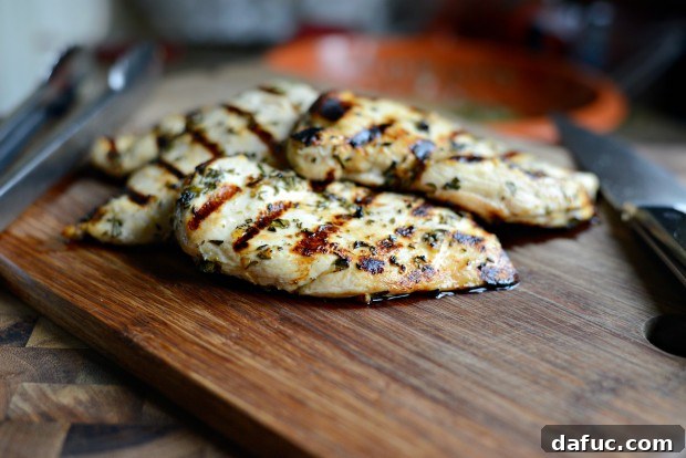 Zesty Grilled Greek Chicken 18 Flipping grilled Greek chicken on the grill