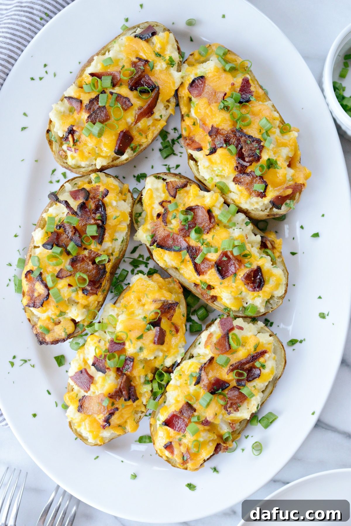 Decadent Double-Baked Potato Delight 2 Loaded Twice Baked Potatoes, perfectly golden brown and overflowing with cheese and bacon
