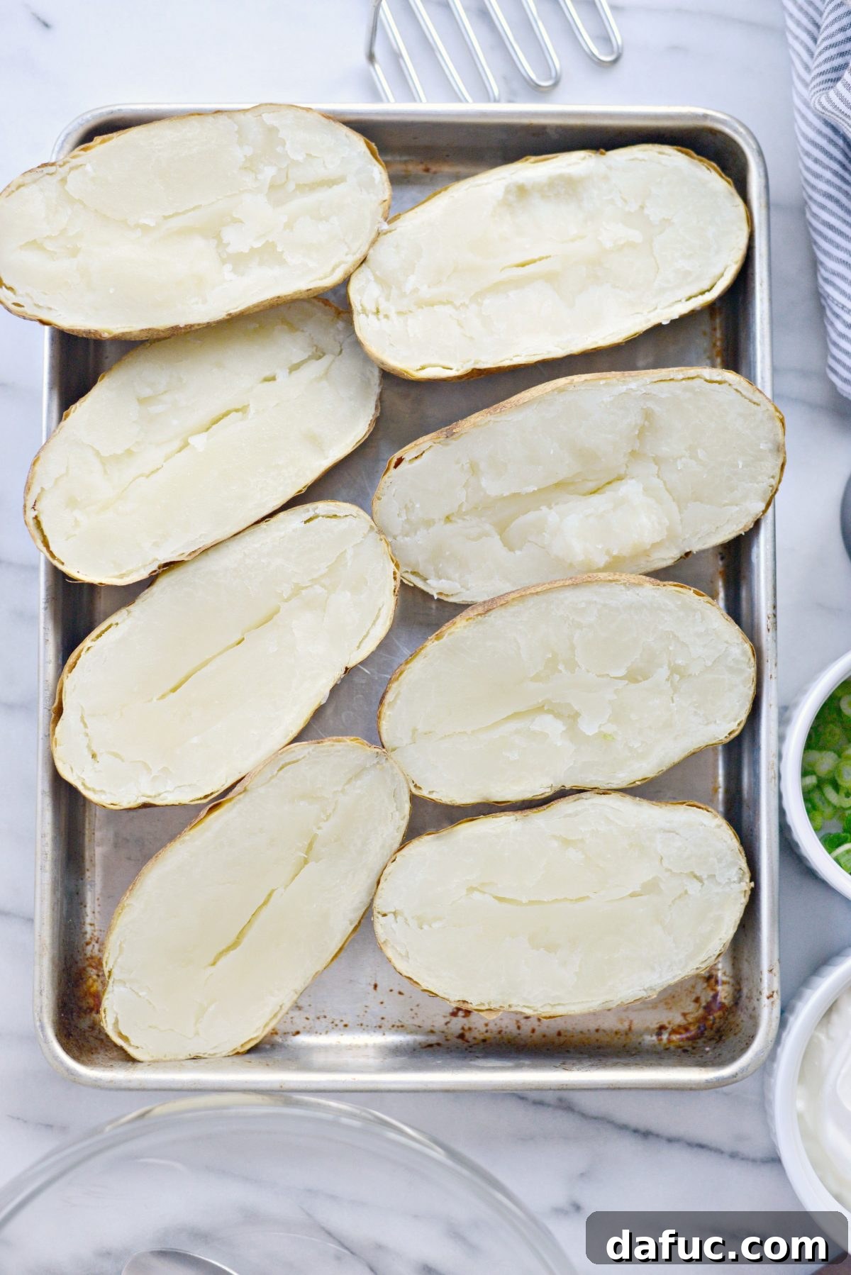 Decadent Double-Baked Potato Delight 5 Baked russet potatoes cut in half, ready for scooping