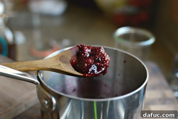 Finished Cherry Chia Jam, thick and glossy, cooling in the saucepan.