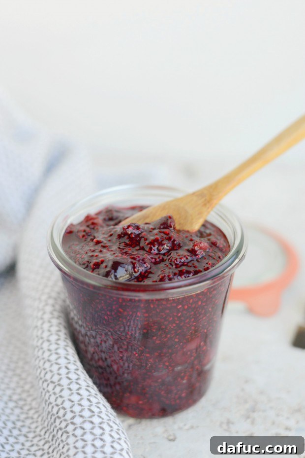 Final glamour shot of Cherry Chia Jam on a serving spoon, showcasing its rich texture.