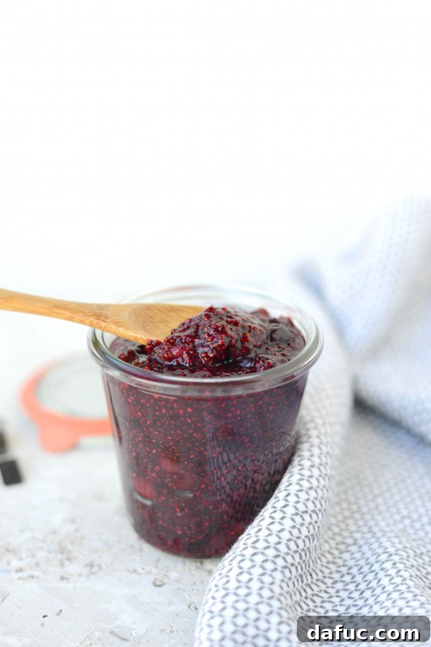 Freshly made Cherry Chia Jam spread on toast, showing its delightful texture.
