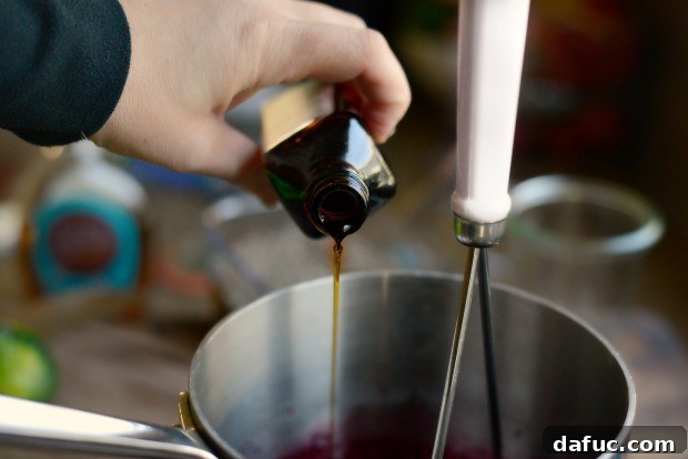 A tablespoon of pure maple syrup being added to the cherry mixture.