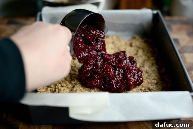 Sweet Cherry Almond Crumble Bars 16 Spreading cherry jam evenly over the baked oatmeal base