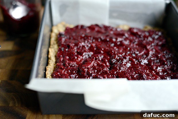 Sweet Cherry Almond Crumble Bars 17 Cherry jam spread over the oatmeal bar base, leaving a small border