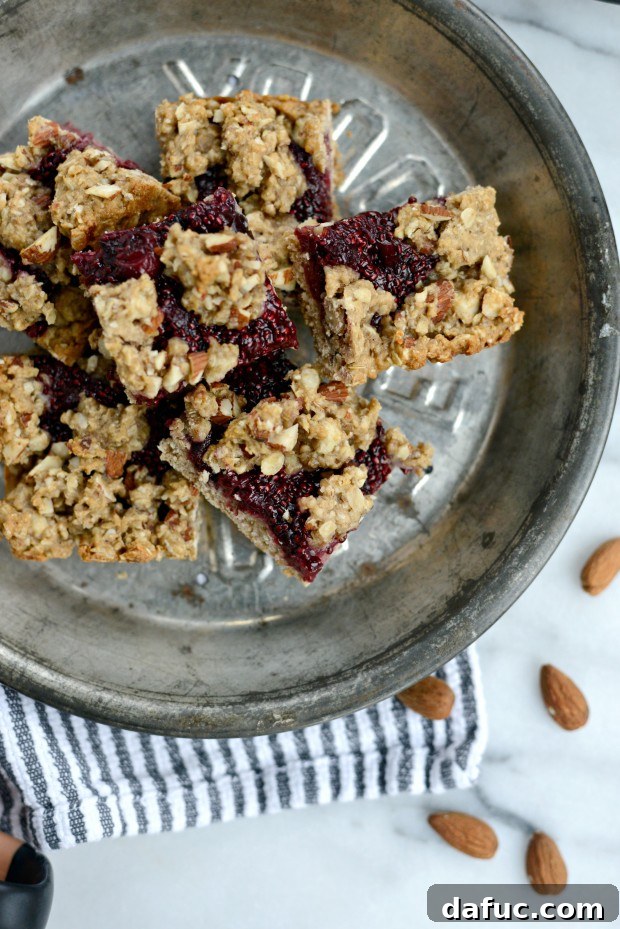 Sweet Cherry Almond Crumble Bars 24 Hand holding a square of Cherry Jam Almond Crumble Breakfast Bar