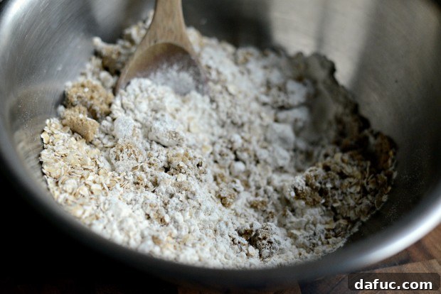 Sweet Cherry Almond Crumble Bars 7 Mixing dry ingredients in a bowl with a wooden spoon