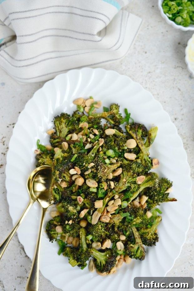 Savory Roasted Broccoli with Toasted Peanuts 3 A close-up of roasted broccoli and peanuts in a bowl, showing the crispy texture of the broccoli florets.