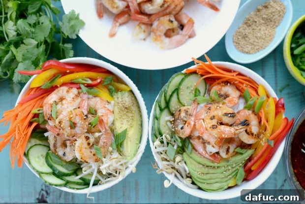 Vibrant Grilled Shrimp Spring Roll Noodle Bowls 11 Grilled shrimp being placed on top of the assembled noodle bowl.