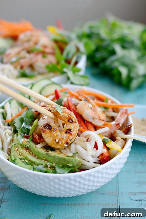 Vibrant Grilled Shrimp Spring Roll Noodle Bowls 16 Beautifully garnished grilled shrimp spring roll noodle bowl, ready to be enjoyed.