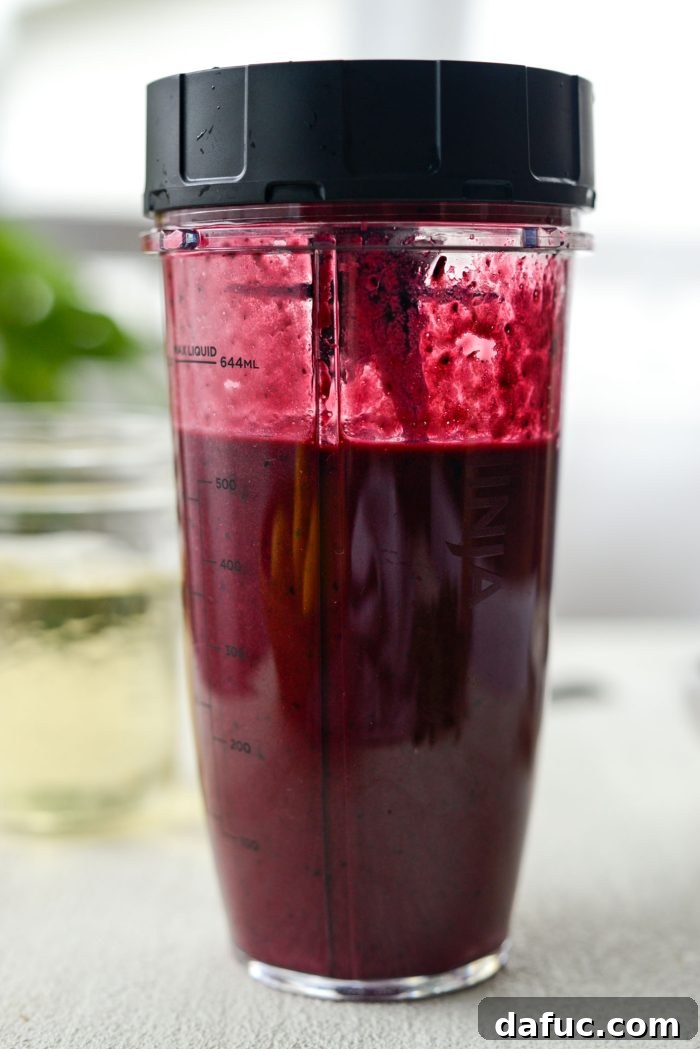 Pureeing the cooled blueberry lemon mixture in a blender