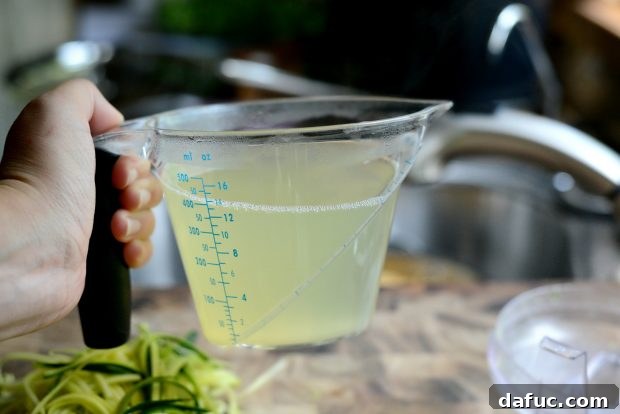 Adding pasta water to thin the pesto sauce