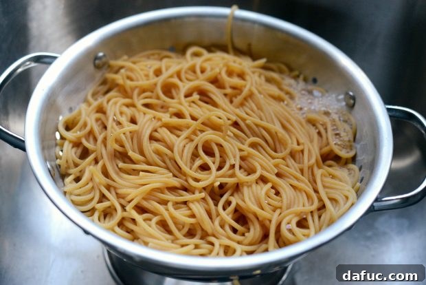 Tossing pasta with zucchini ribbons and Parmesan