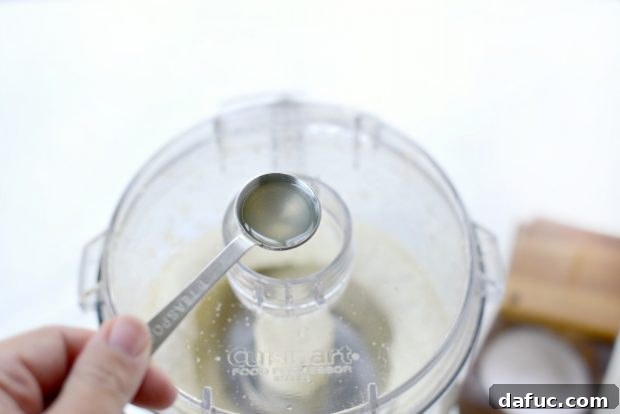 Creamy Lebanese Toum 11 Allowing the processor to blend after adding oil.