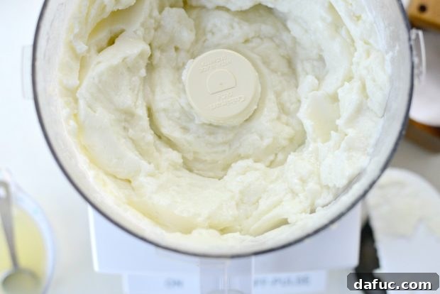 Creamy Lebanese Toum 12 Adding fresh lemon juice to the food processor.