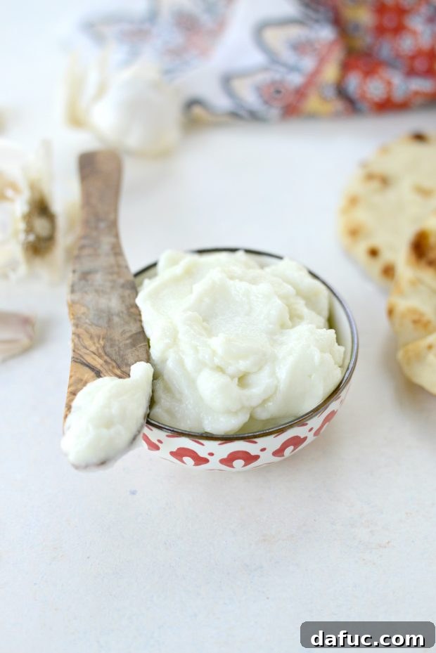 Creamy Lebanese Toum 20 Serving of Toum with a fork.
