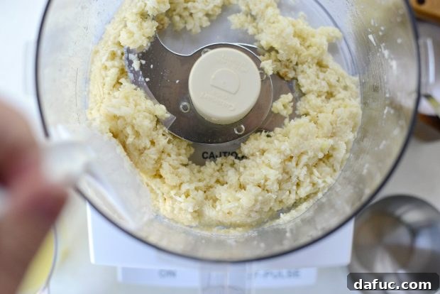 Creamy Lebanese Toum 8 Scraping down the sides of the food processor.