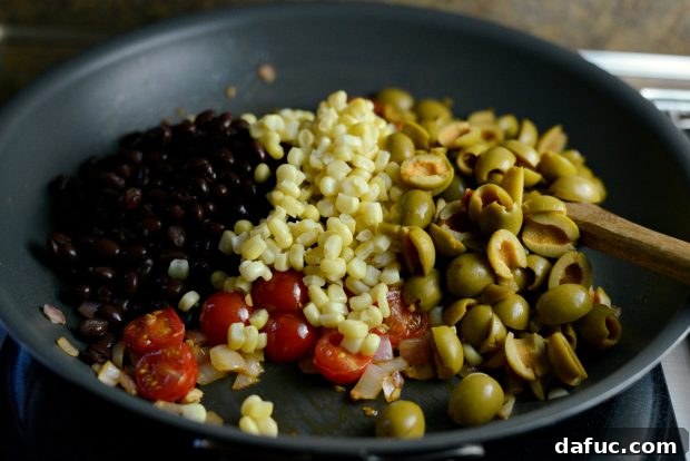 Grilled Red Snapper with a Vibrant Fiesta Olive Medley 11 Black beans, sweet yellow corn, and halved olives added to the skillet.