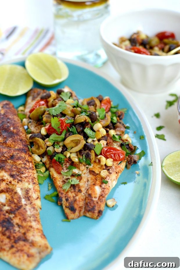 Grilled Red Snapper with a Vibrant Fiesta Olive Medley 19 A perfectly grilled red snapper fillet on a plate, ready to be topped with the warm fiesta olive mixture.
