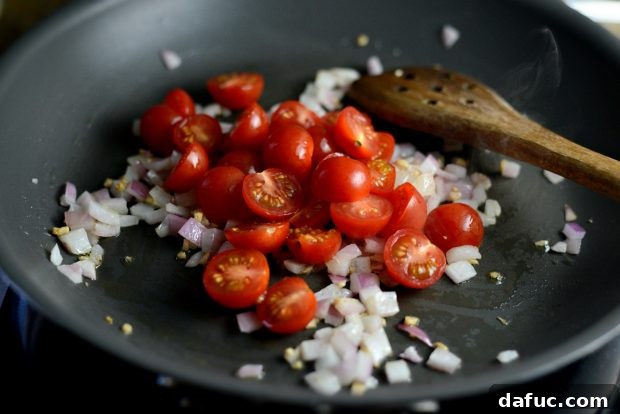 Grilled Red Snapper with a Vibrant Fiesta Olive Medley 9 Halved cherry tomatoes added to the sautéed onions and garlic in the skillet.