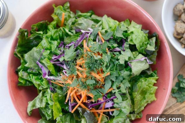 Adding fresh dill and parsley to the salad greens