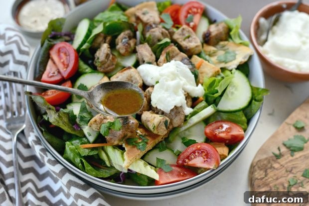 Plating Chicken Tawook Salad with cucumber, red onion, tomato, and grilled chicken