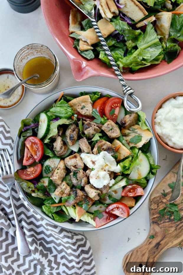 Chicken Tawook Salad topped with creamy Lebanese garlic sauce and lemon sumac dressing
