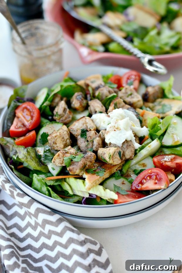 Close-up of vibrant Chicken Tawook Salad ingredients with lemon sumac dressing