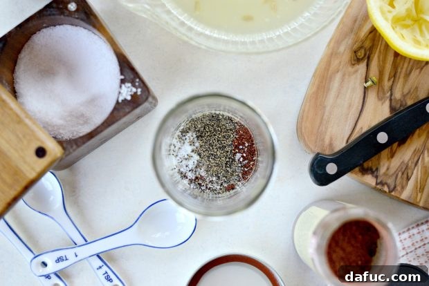 Seasoning the lemon sumac dressing with kosher salt and black pepper
