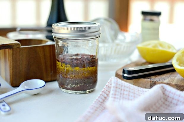 Jar of lemon sumac dressing with lid secured, ready to shake