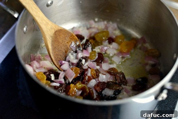Golden Moroccan Quinoa Pilaf 8 Stirring Raisins into the Mixture