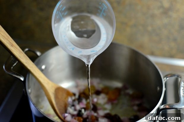 Golden Moroccan Quinoa Pilaf 10 Pouring Water into the Pilaf Base