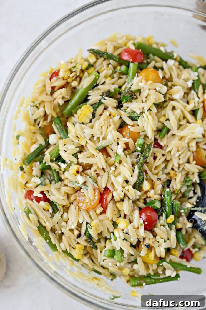 Vibrant Grilled Corn Orzo Salad 16 The fully dressed orzo pasta salad, glistening and ready to be served, with a hint of extra feta and pepper.