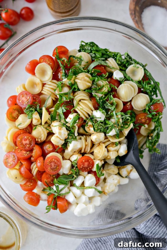 Garden Fresh Caprese Pasta 12 Tossing the Caprese Pasta Salad with dressing