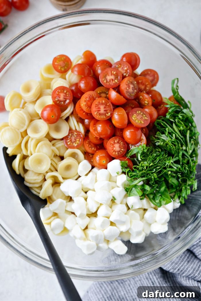 Garden Fresh Caprese Pasta 10 Pasta, tomatoes, mozzarella, and basil in a bowl