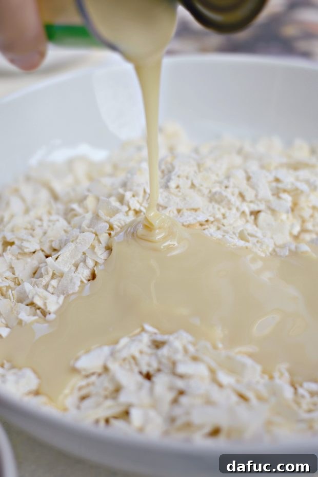 Blissful Almond Macarons 5 Add in sweetened condensed milk, almond and vanilla extract to coconut mixture