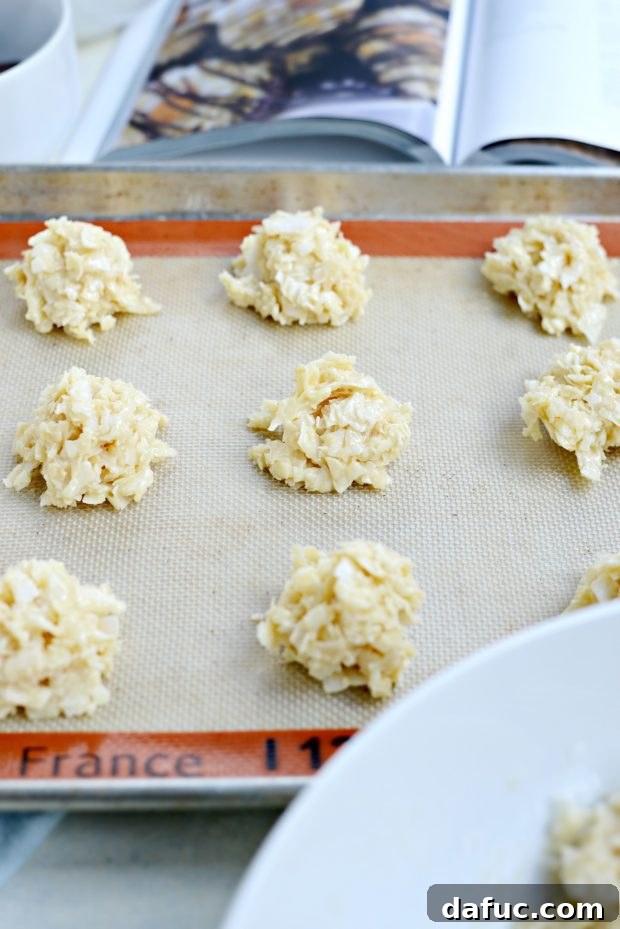 Blissful Almond Macarons 7 spoonfuls of coconut mixture on lined baking pan ready for oven